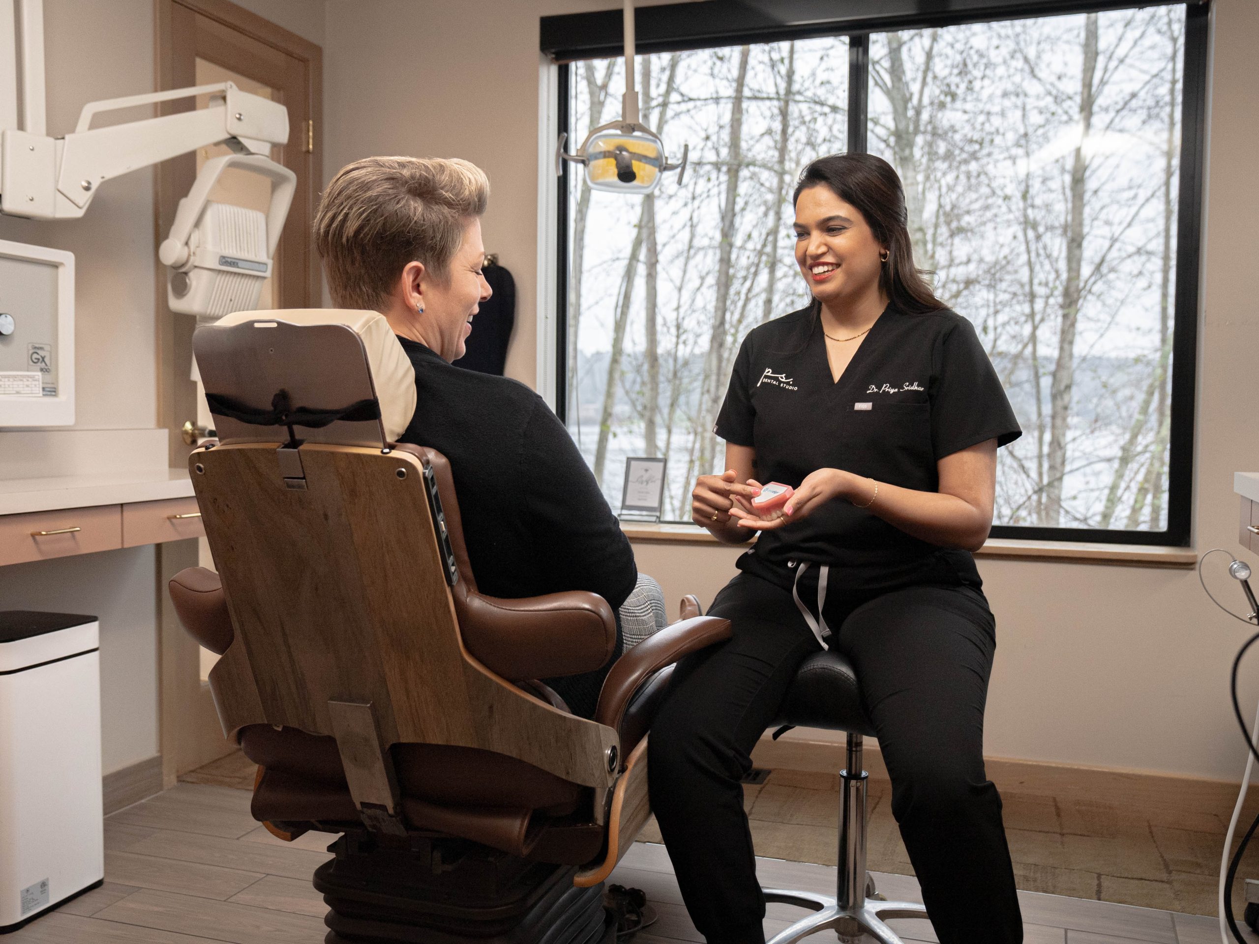 Dr. Priya Sridhar explaining a treatment plan to a patient at PS Dental Studio