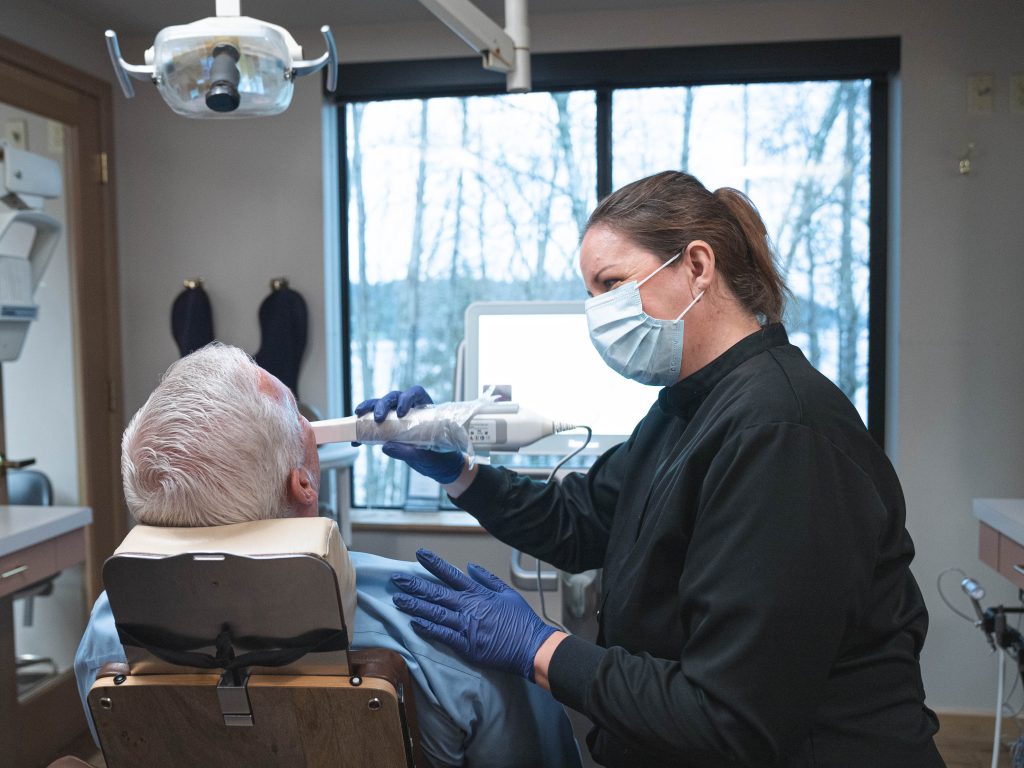 Dr. Priya Sridhar reviewing a patient's smile during a no-prep veneer consultation at PS Dental Studio in Kenmore